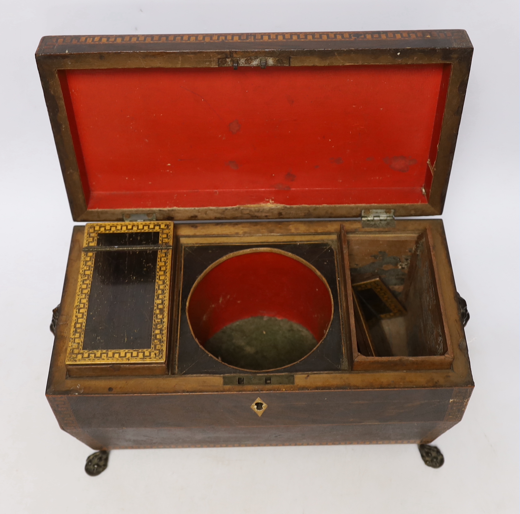 A Regency inlaid rosewood tea caddy, with two canisters, gilt brass handles and claw feet, 20cm high